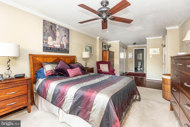 bedroom featuring crown molding, light carpet, a textured ceiling, and ceiling fan