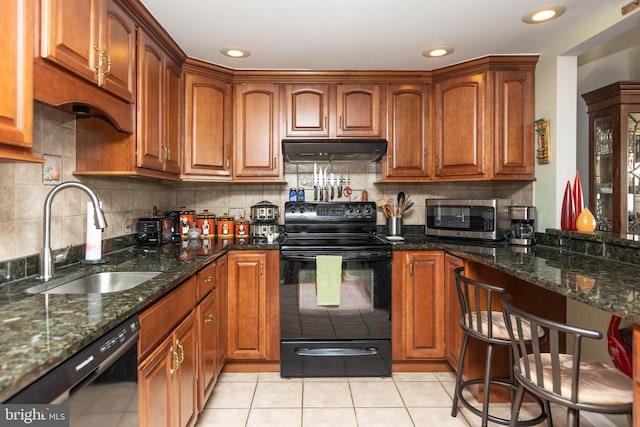 kitchen with tasteful backsplash, dark stone counters, sink, and black appliances