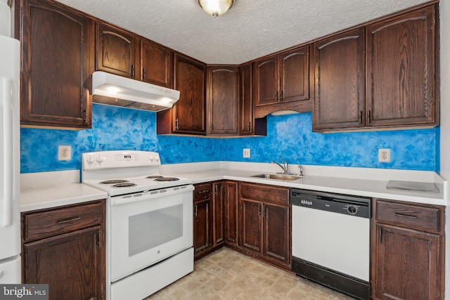 kitchen with white appliances, dark brown cabinetry, sink, and a textured ceiling