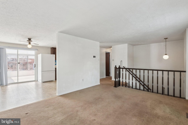 carpeted spare room featuring a textured ceiling