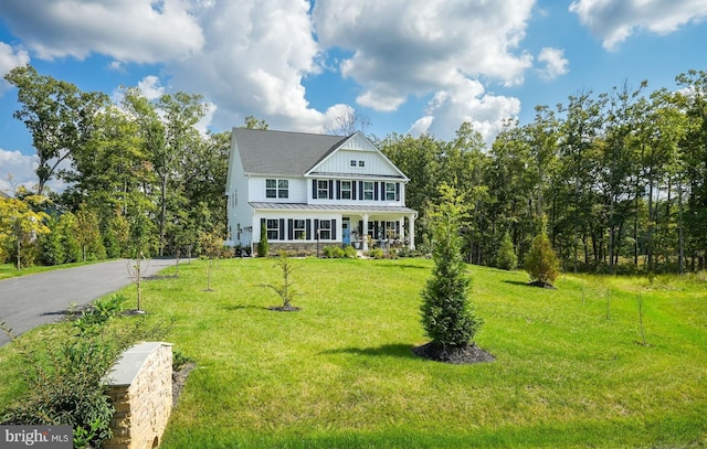 view of front of house with a front yard and a porch