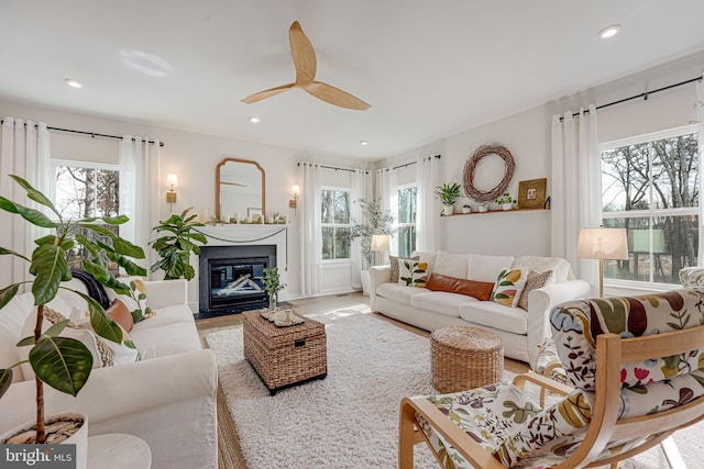 living room with a wealth of natural light and ceiling fan