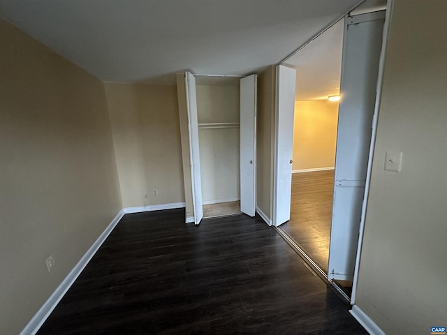 unfurnished bedroom with dark hardwood / wood-style floors