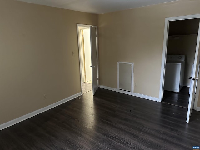 empty room featuring washer / clothes dryer and dark hardwood / wood-style floors