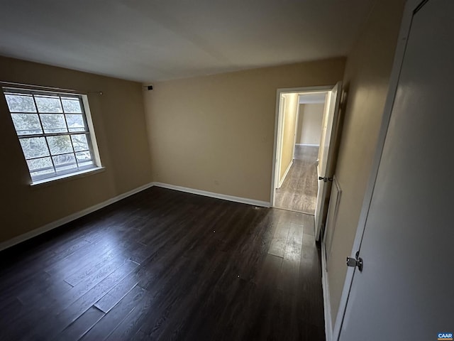 spare room with dark hardwood / wood-style floors