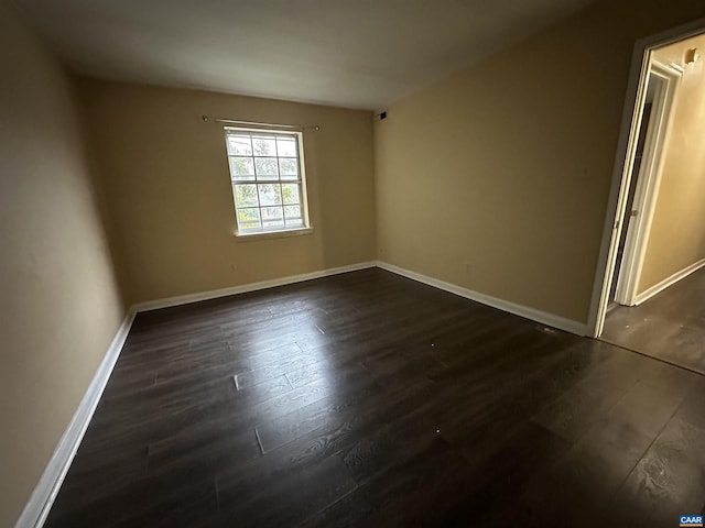 empty room featuring dark hardwood / wood-style flooring