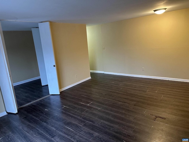 unfurnished room featuring dark hardwood / wood-style flooring