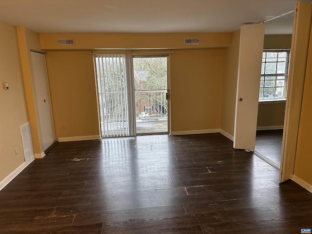 empty room with dark hardwood / wood-style flooring