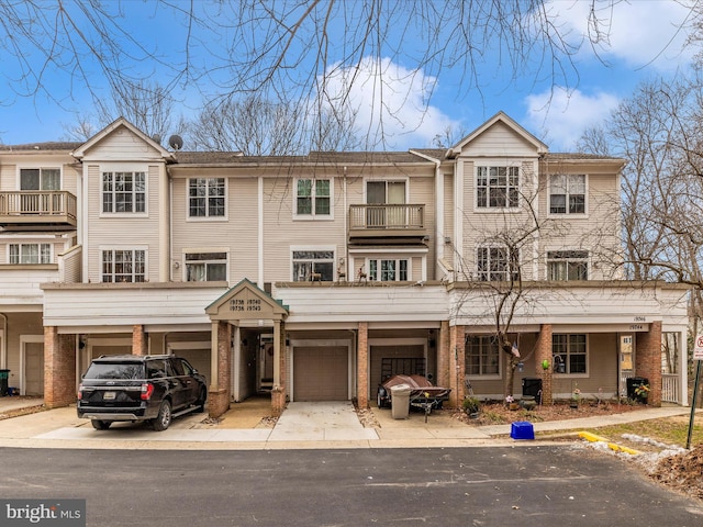 view of front of property featuring a garage, brick siding, and driveway