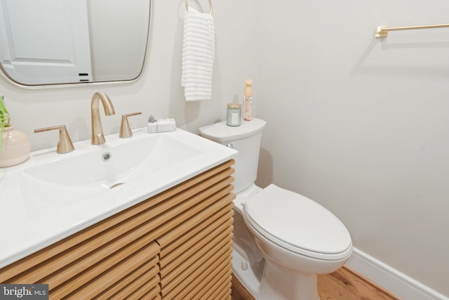 bathroom with vanity, hardwood / wood-style floors, and toilet