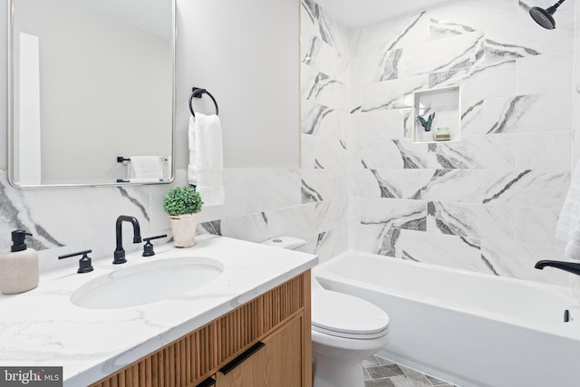 full bathroom with tiled shower / bath combo, vanity, tile walls, and toilet