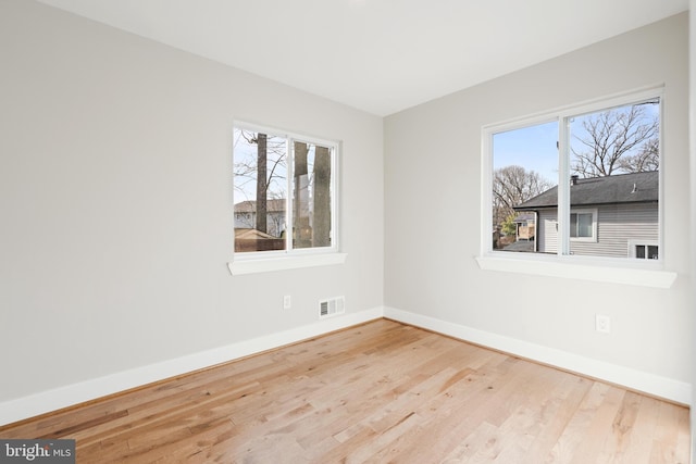 unfurnished room with light hardwood / wood-style flooring