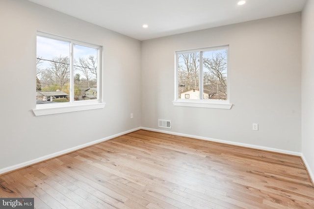 empty room with light hardwood / wood-style flooring