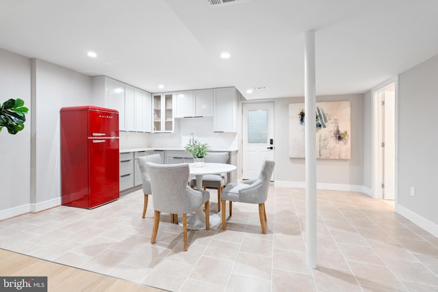 tiled dining room featuring sink