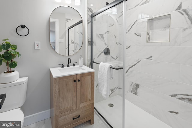 bathroom featuring vanity, toilet, and walk in shower