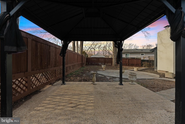 patio terrace at dusk featuring a gazebo