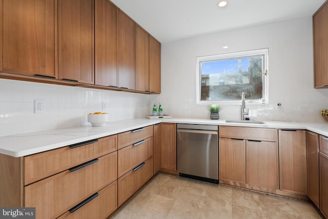 kitchen featuring sink, decorative backsplash, and stainless steel dishwasher