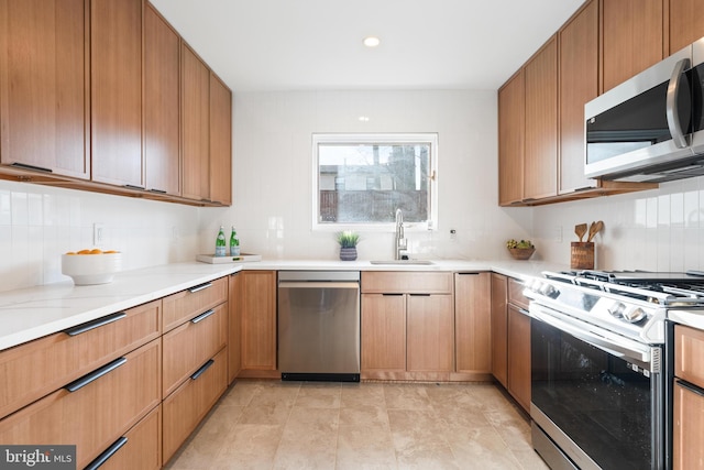 kitchen featuring tasteful backsplash, appliances with stainless steel finishes, and sink