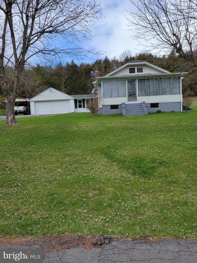 view of front of home with a garage and a front lawn