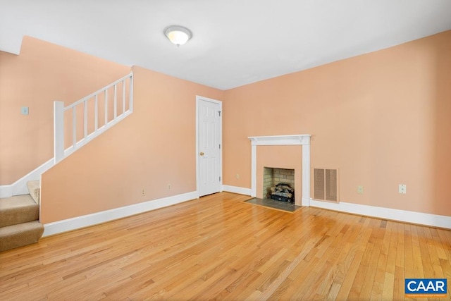 unfurnished living room with wood-type flooring