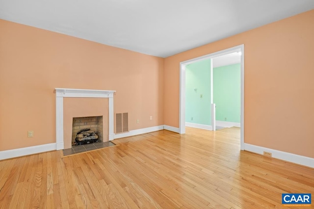 unfurnished living room featuring hardwood / wood-style flooring