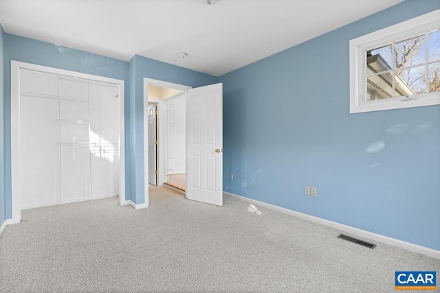 unfurnished bedroom with carpet floors and a closet