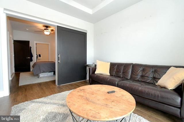 living room with ceiling fan and dark hardwood / wood-style floors