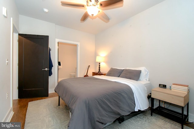 bedroom with hardwood / wood-style floors, ensuite bath, and ceiling fan