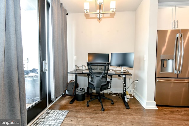 office featuring light hardwood / wood-style flooring and a chandelier