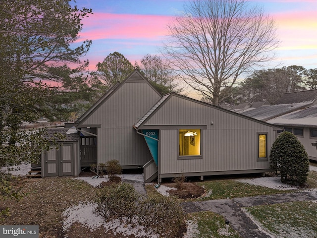 view of back house at dusk