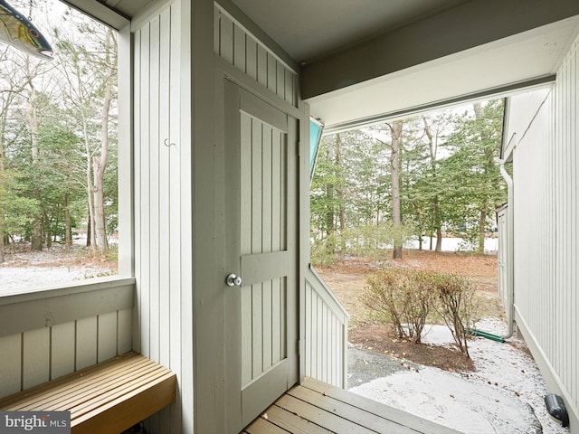 doorway featuring wooden walls