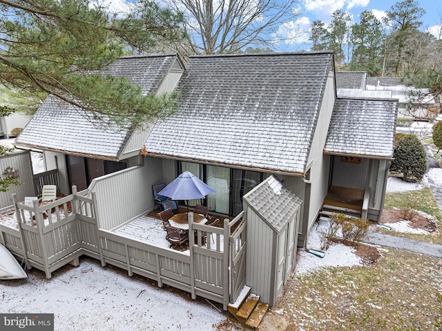 view of snow covered exterior with a deck