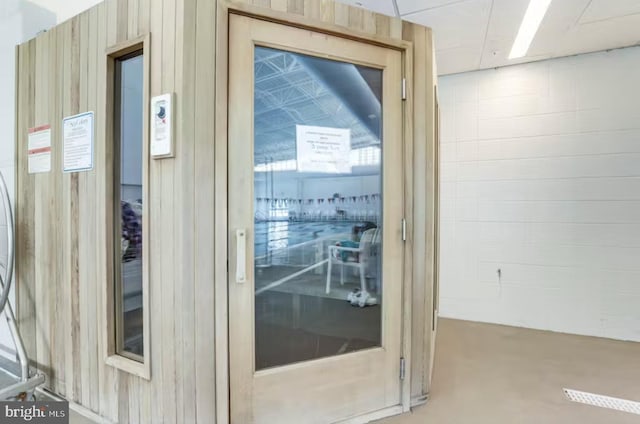 doorway featuring wooden walls