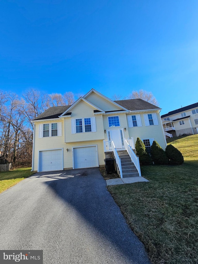 view of front of house with a garage and a front lawn