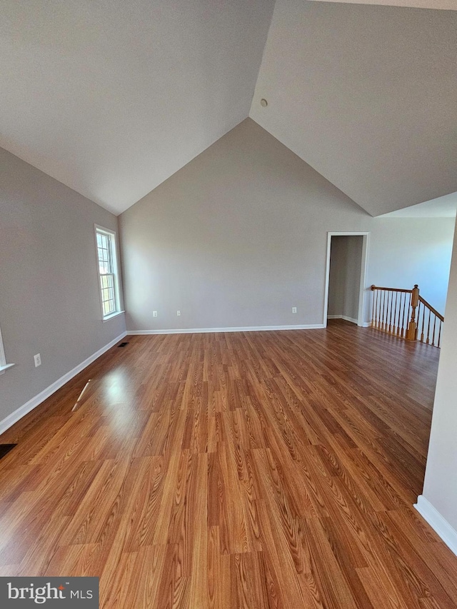 unfurnished living room with lofted ceiling and light hardwood / wood-style flooring