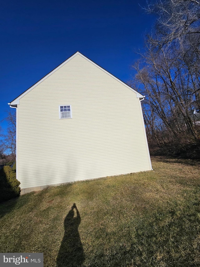 view of home's exterior with a yard