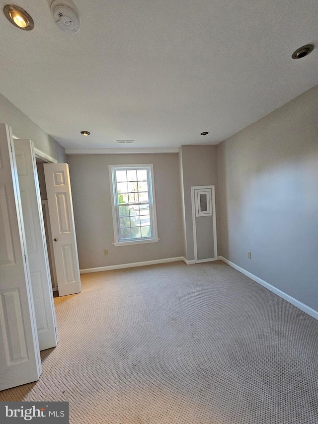 unfurnished room with light colored carpet