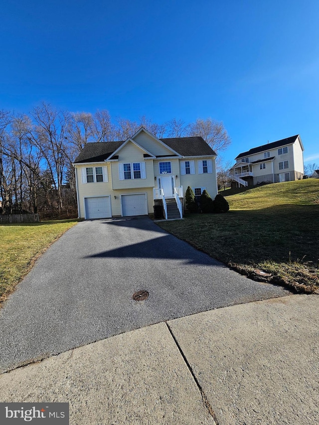 bi-level home with a garage and a front yard