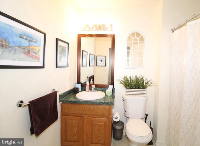 bathroom with vanity, curtained shower, and toilet