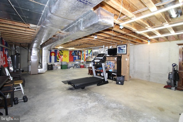 basement featuring heating unit and water heater