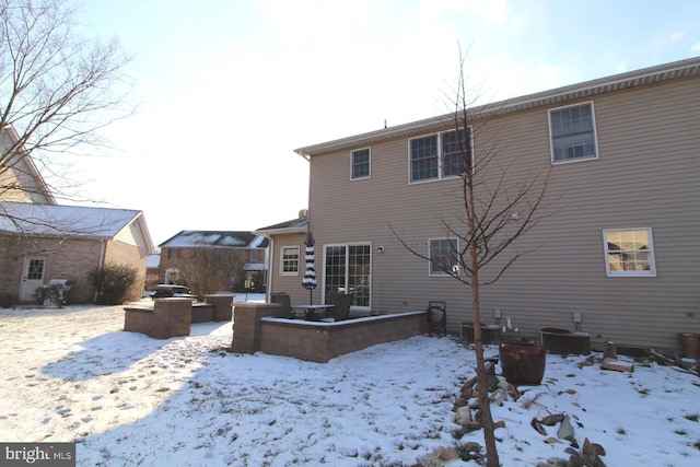 snow covered property featuring cooling unit