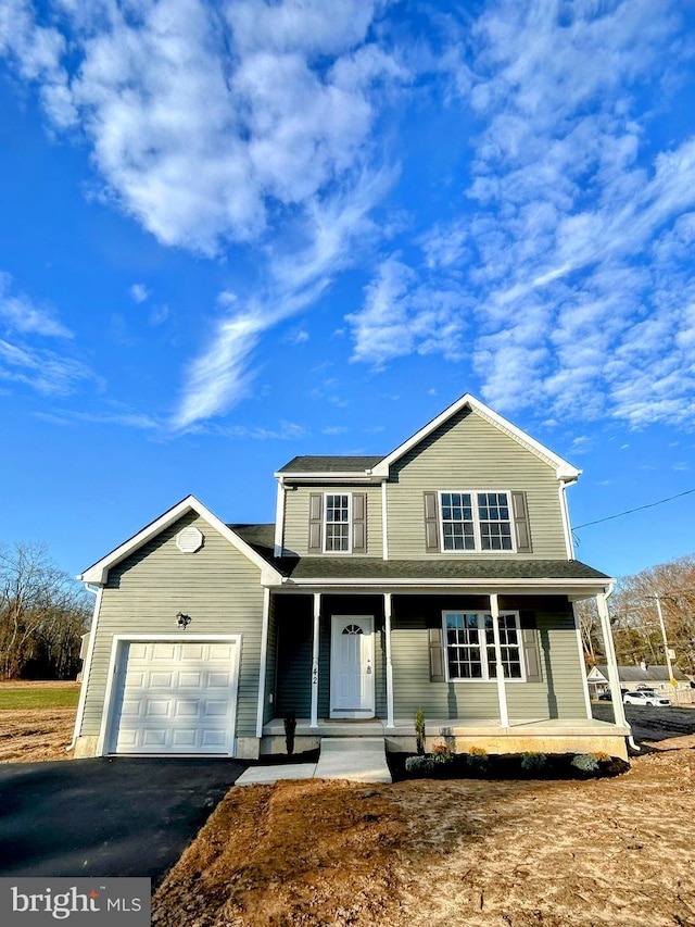 view of property featuring a porch and a garage