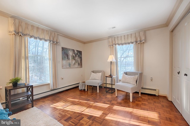 sitting room featuring parquet floors, crown molding, and a healthy amount of sunlight