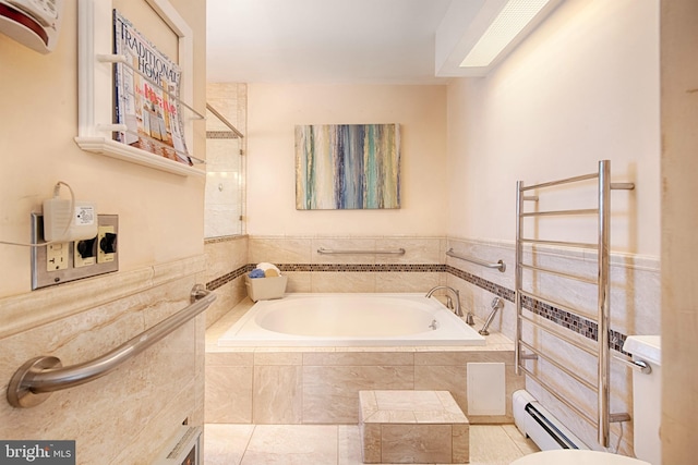 bathroom featuring a baseboard heating unit and tiled bath