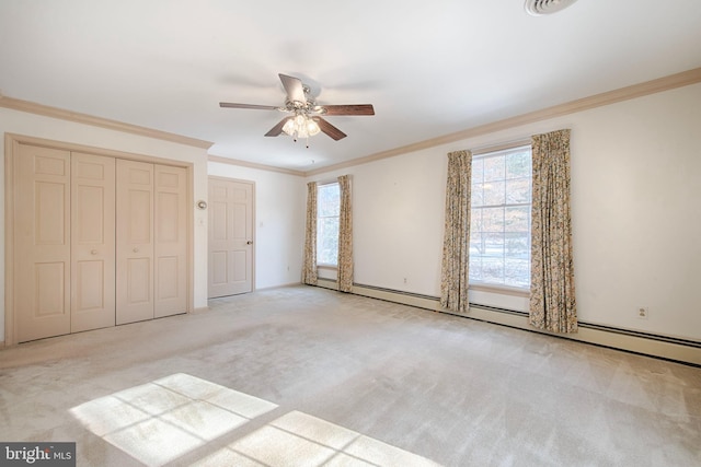 unfurnished bedroom featuring light carpet, a baseboard heating unit, crown molding, and ceiling fan