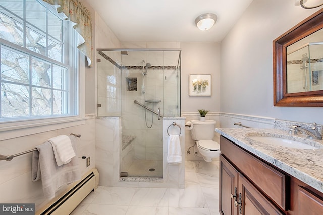 bathroom with vanity, a shower with door, toilet, and baseboard heating