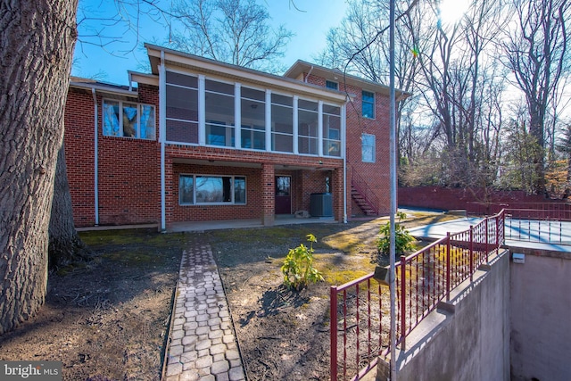 back of house featuring cooling unit and a sunroom