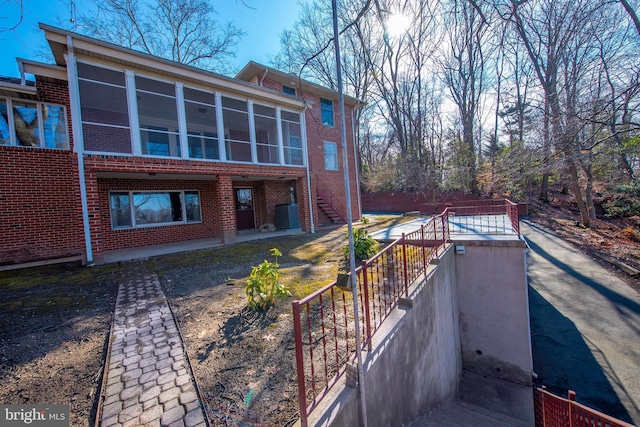 rear view of property with a sunroom