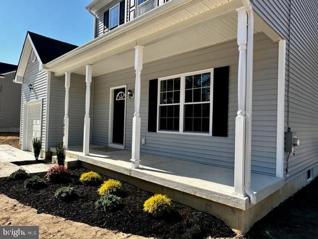 view of exterior entry with a porch