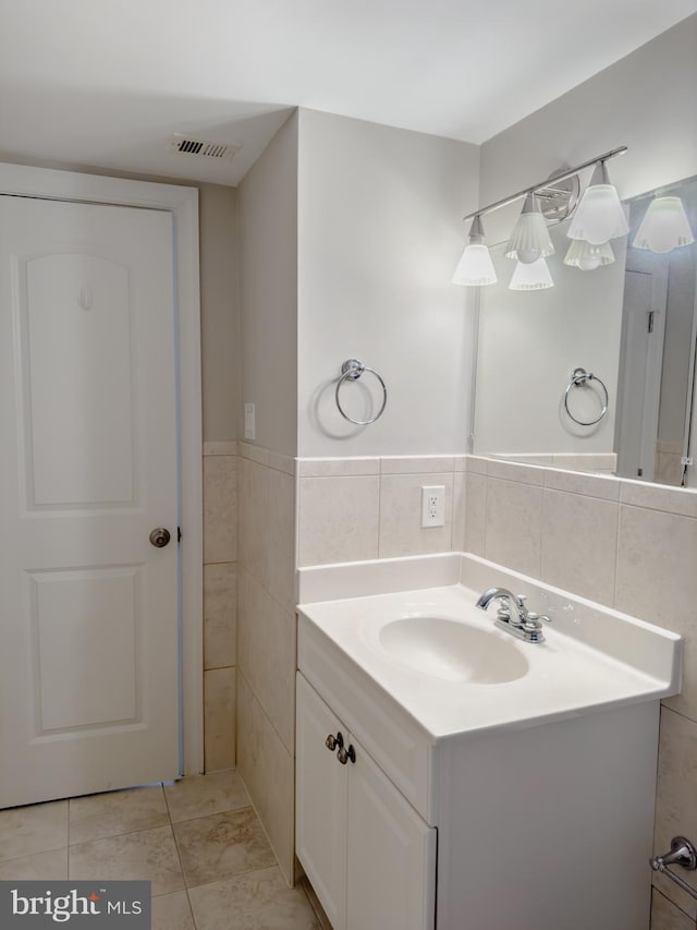 bathroom with vanity, tile walls, and tile patterned floors